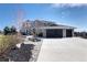 Stunning two-story home featuring a three-car garage, stone accents, and professionally landscaped front yard at 14712 Kalamath Ct, Westminster, CO 80023