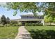 Spacious home featuring a covered patio with views of the well-manicured lawn and garden at 14712 Kalamath Ct, Westminster, CO 80023