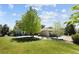 Landscaped lawn featuring an exterior view of the home with stone accents and a spacious backyard at 14712 Kalamath Ct, Westminster, CO 80023