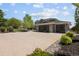 Charming home showcasing a wide driveway and a three-car garage complemented by stone and lush landscaping at 14712 Kalamath Ct, Westminster, CO 80023
