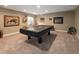 Spacious game room featuring a covered pool table, carpeted floor, and decorative lighting for entertainment at 14712 Kalamath Ct, Westminster, CO 80023