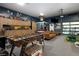 Spacious, well-organized garage with a foosball table, lounge area, and ample storage cabinets at 14712 Kalamath Ct, Westminster, CO 80023