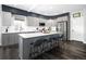 Modern kitchen featuring gray cabinetry, stainless steel appliances, a center island, and dark wood floors at 14712 Kalamath Ct, Westminster, CO 80023