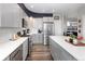 Updated kitchen with stainless steel appliances, gray cabinets, a white backsplash, and stylish countertops at 14712 Kalamath Ct, Westminster, CO 80023