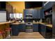 Stylish kitchenette features dark blue cabinetry, stainless steel appliances, and butcher block countertops at 14712 Kalamath Ct, Westminster, CO 80023