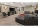 Spacious living room with a large sectional sofa, mounted TV, and unique decor including antlers and animal skulls at 14712 Kalamath Ct, Westminster, CO 80023
