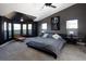 Main bedroom with dark walls, carpet floors, a modern bed frame, and a sitting area with a corner window at 14712 Kalamath Ct, Westminster, CO 80023