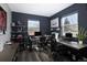Home office with dual desk setup, dark walls, natural light, and sleek contemporary design at 14712 Kalamath Ct, Westminster, CO 80023