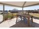 Covered patio featuring a wooden table with outdoor dining seating overlooking a grassy backyard at 14712 Kalamath Ct, Westminster, CO 80023
