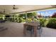 Covered patio with outdoor seating, a ceiling fan, and a view of the landscaped backyard at 14712 Kalamath Ct, Westminster, CO 80023