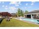 Backyard pool area complete with seating, basketball hoops, lush turf, and mature landscaping at 14712 Kalamath Ct, Westminster, CO 80023