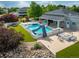 Backyard inground pool with slide, patio, seating, and beautiful landscaping for outdoor entertainment at 14712 Kalamath Ct, Westminster, CO 80023