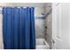 Updated bathroom featuring blue tile accents, a shower with blue curtain, and modern fixtures at 19437 E Mann Creek Dr # A, Parker, CO 80134
