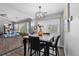 Stylish dining room with modern lighting, wood floors, and bright window at 19437 E Mann Creek Dr # A, Parker, CO 80134