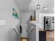 Bright entryway featuring a modern light fixture, stainless steel refrigerator, and white cabinets at 19437 E Mann Creek Dr # A, Parker, CO 80134