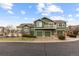 Inviting townhouse featuring a three-car garage, balcony, and charming architectural details at 19437 E Mann Creek Dr # A, Parker, CO 80134