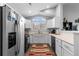 Well-lit kitchen showcases white cabinets, a large window, and modern appliances at 19437 E Mann Creek Dr # A, Parker, CO 80134