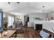 Bright living room boasts wood floors, vaulted ceilings, and neutral decor at 19437 E Mann Creek Dr # A, Parker, CO 80134