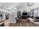 Open-concept living room and kitchen featuring sleek appliances, modern decor, and abundant natural light at 19437 E Mann Creek Dr # A, Parker, CO 80134