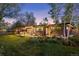 A covered outdoor patio, lush lawn, and an inviting exterior create a perfect setting for relaxation at 8955 E 19Th Ave, Aurora, CO 80010