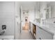 Modern bathroom showcasing white cabinets, sleek fixtures, and a view into the hallway at 8955 E 19Th Ave, Aurora, CO 80010