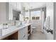 Bathroom with double sink, modern fixtures, white countertop and cabinets, and large mirror at 8955 E 19Th Ave, Aurora, CO 80010