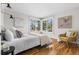 Bright bedroom with hardwood floors, large windows, and stylish decor, offering a cozy retreat at 8955 E 19Th Ave, Aurora, CO 80010