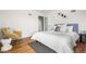 Bedroom featuring hardwood floors, a plush bed, and minimalist design, with accent chair at 8955 E 19Th Ave, Aurora, CO 80010