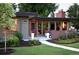 Charming single-story home featuring a manicured lawn, professional landscaping, and an inviting red front door at 8955 E 19Th Ave, Aurora, CO 80010