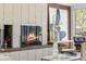 Close up of a brick fireplace in the living room with modern furniture and decor at 8955 E 19Th Ave, Aurora, CO 80010