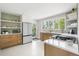 Bright kitchen featuring white countertops, modern appliances, open shelving, and ample natural light for a clean, stylish design at 8955 E 19Th Ave, Aurora, CO 80010