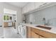 Convenient laundry room featuring washer, dryer, modern cabinets, and a sink, seamlessly blending functionality with style at 8955 E 19Th Ave, Aurora, CO 80010
