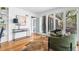 Bright living room featuring hardwood floors, modern decor, and large windows, and open door at 8955 E 19Th Ave, Aurora, CO 80010