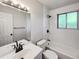 Bathroom featuring a shower-tub combo, vanity, and tile flooring at 9065 Cody Ct, Broomfield, CO 80021