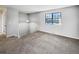 Carpeted landing at the top of stairs with overhead lighting and large window at 9065 Cody Ct, Broomfield, CO 80021