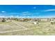 Expansive aerial view of the property features a home, green yard, and white fencing at 2188 Savage Rd, Elizabeth, CO 80107