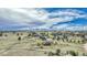 Scenic aerial view of homes and a large open area under a blue sky with light clouds at 2188 Savage Rd, Elizabeth, CO 80107