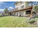 Lush backyard featuring a spacious deck, outdoor seating, and mature trees at 2188 Savage Rd, Elizabeth, CO 80107