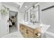 Stylish bathroom with double vanity, sleek mirrors, modern lighting, and view to main bedroom at 2188 Savage Rd, Elizabeth, CO 80107