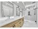 Modern bathroom with a dual vanity, sleek fixtures, walk-in shower with marble tile, and natural light at 2188 Savage Rd, Elizabeth, CO 80107