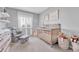 Cozy Bedroom featuring a crib, rocking chair, and soft decor, creating a comforting space at 2188 Savage Rd, Elizabeth, CO 80107