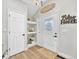 Bright entryway with hardwood floors, decorative shelves, and a charming welcome sign at 2188 Savage Rd, Elizabeth, CO 80107