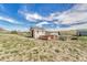 Charming shed with garden beds and clear blue sky provides additional outdoor space and storage at 2188 Savage Rd, Elizabeth, CO 80107