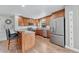 Spacious kitchen with stainless steel appliances, bar seating, and wood cabinets at 2188 Savage Rd, Elizabeth, CO 80107