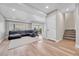 Spacious living room featuring a comfortable black leather sectional and bright, natural light at 2188 Savage Rd, Elizabeth, CO 80107