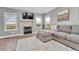 Cozy living room featuring a fireplace, large sectional, bright windows, and a mounted TV at 2188 Savage Rd, Elizabeth, CO 80107