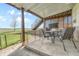 Covered patio with outdoor dining set, perfect for enjoying meals and relaxing in a shaded area at 2188 Savage Rd, Elizabeth, CO 80107
