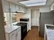 Galley style kitchen with white cabinetry and granite countertops at 1920 S Oswego Way, Aurora, CO 80014