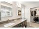 Bathroom featuring double sinks, a walk-in closet, and a glass-enclosed shower at 10906 Pastel Pt, Parker, CO 80134