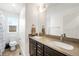 Bright bathroom featuring a double vanity, neutral countertops, and tile flooring near the toilet at 10906 Pastel Pt, Parker, CO 80134